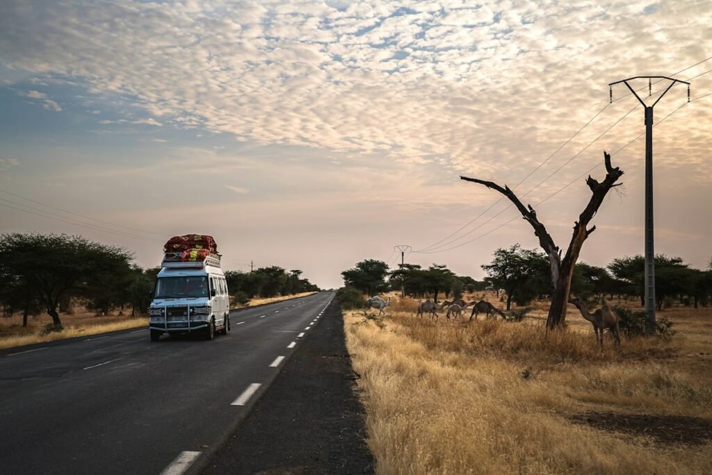 White minivan transfer vehicle on the road